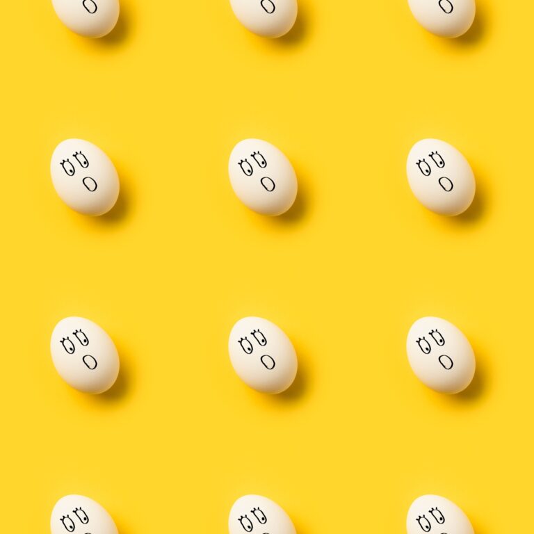 Collection of Painted chicken eggs with shocked emoji isolated on yellow