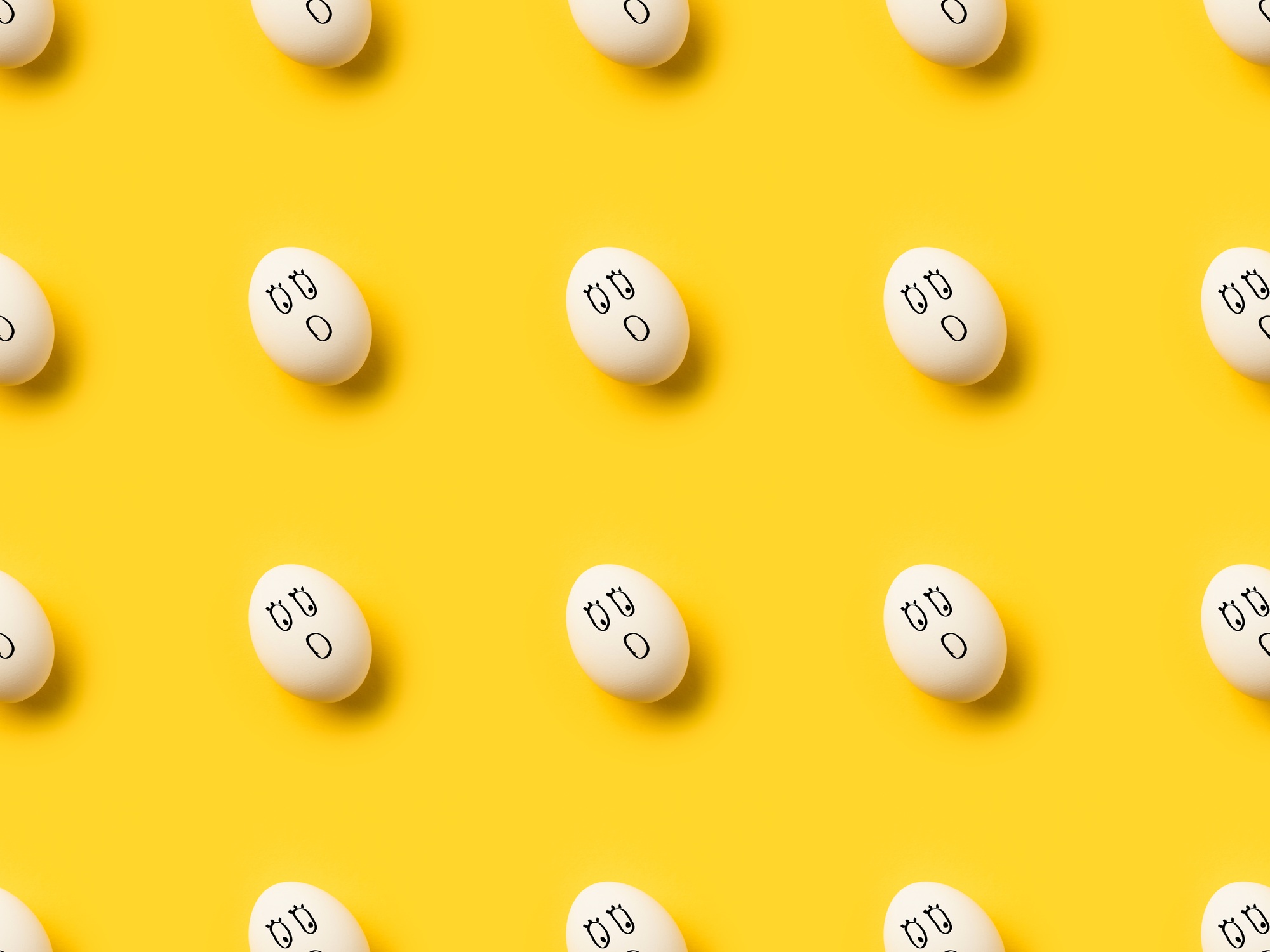 Collection of Painted chicken eggs with shocked emoji isolated on yellow